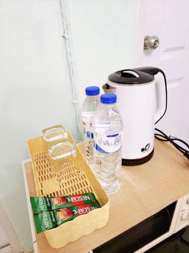 a table with two bottles of water and a blender at 804-STP Homely room Free Wi-Fi and Near BTS line in Bangkok