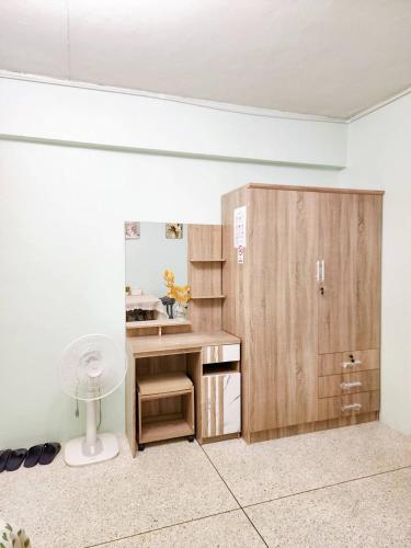 a room with a desk and a closet with a fan at 804-STP Homely room Free Wi-Fi and Near BTS line in Bangkok