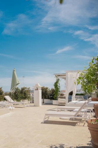 a group of lounge chairs sitting on the beach at Palazzo Maritati in Nardò