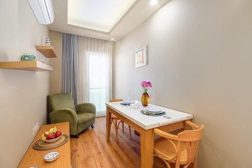 a living room with a table and a chair at The Suites in Antalya