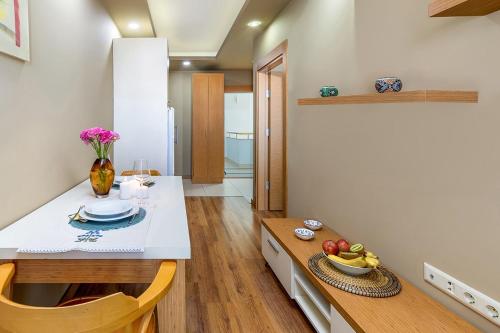 a kitchen with a white counter and a table at The Suites in Antalya