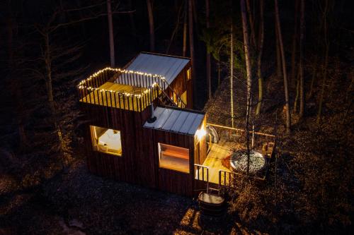 a small tree house with lights on it at night at KarpatyGlamp in Rudimov