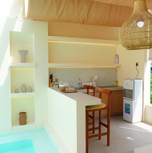 a kitchen with a table and chairs and a sink at Fulton Villa Alexandria 2BR in Sleman