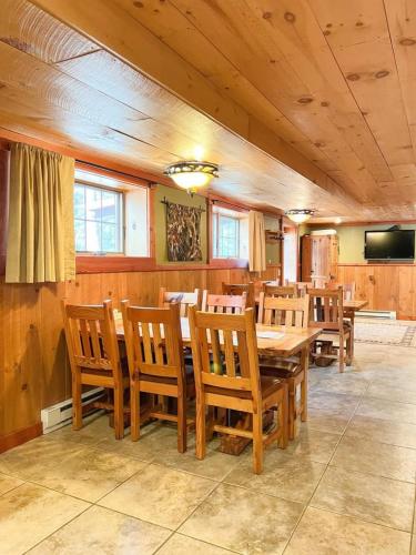 a dining room with wooden tables and chairs at Club 51 in Mercer