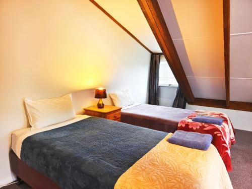a bedroom with two beds and a window at Parakai Geothermal Motel in Parakai
