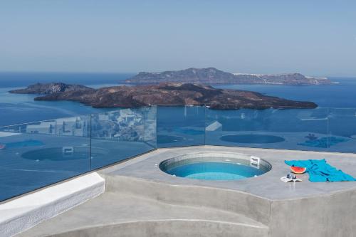 a swimming pool with a view of the ocean at Villa Irini Fira - Adults Only in Fira