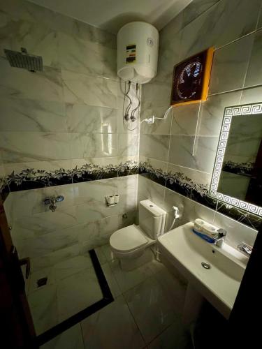 a bathroom with a white toilet and a sink at King house hotel dahab in Dahab