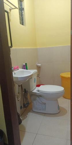 a bathroom with a toilet and a sink at House of DHESSA in Butuan