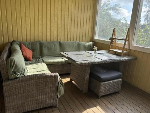 a living room with a table and a couch at Villa Älghult in Älghult