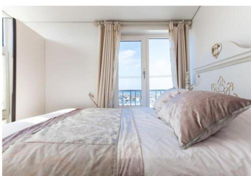 a bedroom with a large bed with a large window at HANI Haus in Jeju