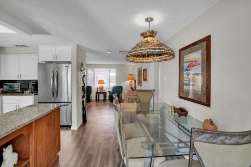 a kitchen and dining room with a glass table at Waterfront Escape with Private Pool & Gulf Access home in Hudson