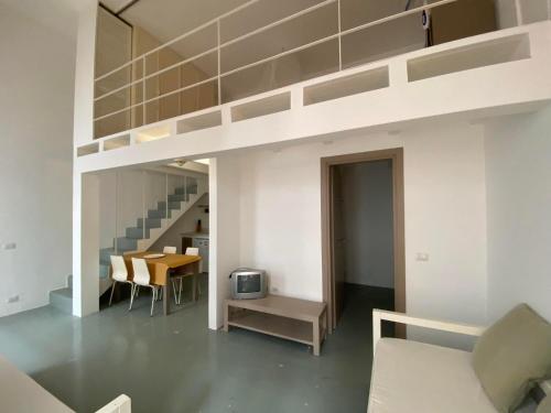 a living room with a loft bed and a dining room at Appartamenti Praia Estoril, Sal Rei, Boa Vista in Sal Rei