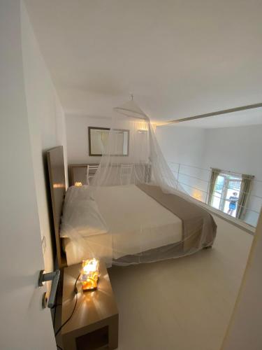 a bedroom with a large bed and a table at Appartamenti Praia Estoril, Sal Rei, Boa Vista in Sal Rei
