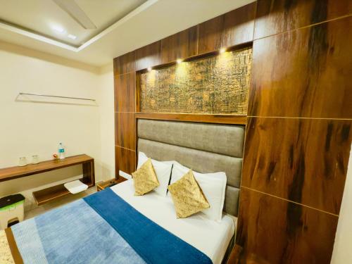 a bedroom with a bed and a wooden wall at The Hydel Park - Business Class Hotel - Near Central Railway Station in Chennai