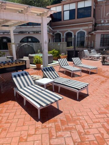 a group of benches sitting on a brick patio at La Terrazza Quisisana Sorrento Coast in Castellammare di Stabia