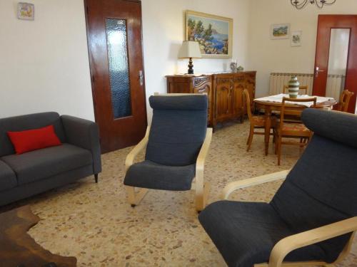a living room with a couch and chairs and a table at La campagne in Cuers