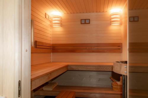 a sauna with wooden walls and wooden flooring at Greenland House in Cēsis