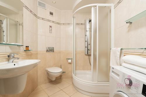 a bathroom with a sink and a toilet and a shower at Your Holidays Campingowa in Międzyzdroje