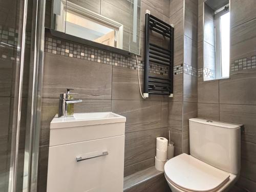 a bathroom with a toilet and a sink at The Seraphina Suite - Chelsea in London
