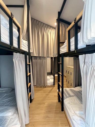 a dorm room with four bunk beds in it at Around Ari Hostel in Bangkok