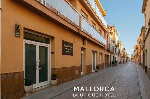 an empty street in front of a building at Mallorca Boutique Hotel in Malgrat de Mar
