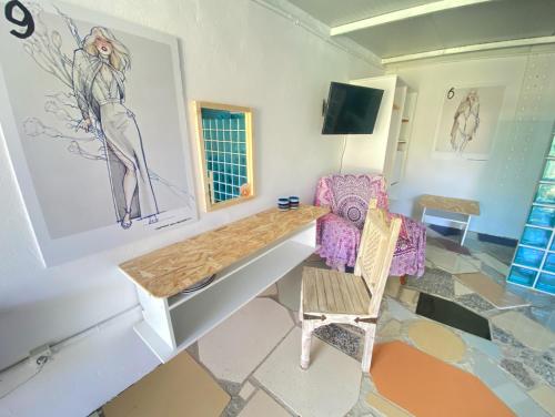 a living room with a table and a chair at Jacaranda in Cádiz