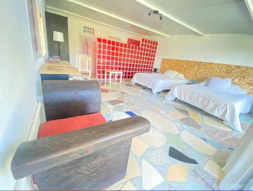 a room with two beds and a floor covered in tiles at Jacaranda in Cádiz