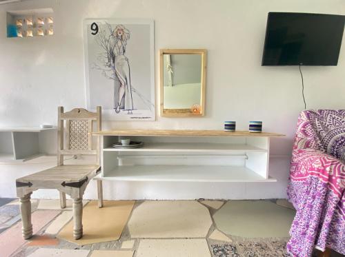 a living room with a table and a chair at Jacaranda in Cádiz