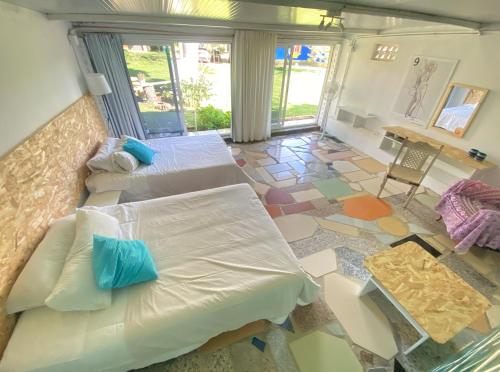 a bedroom with two beds and a table and a table at Jacaranda in Cádiz