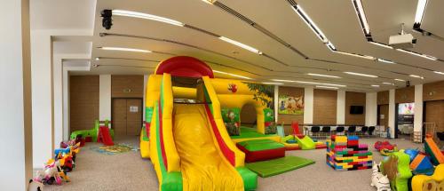 a classroom with a play room with a slide at CE Plaza Hotel in Siófok