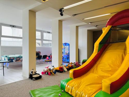 a play room with a slide and many toys at CE Plaza Hotel in Siófok