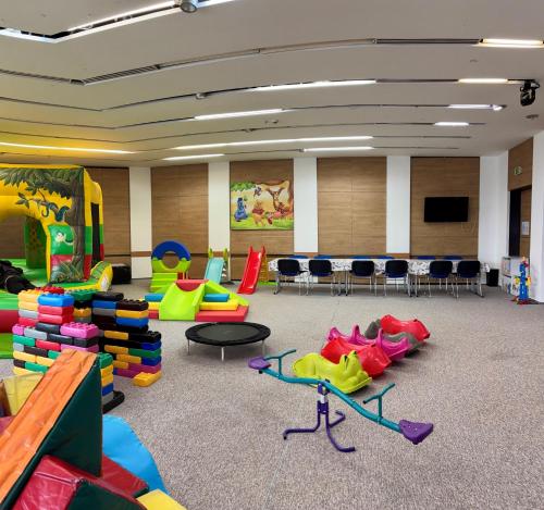 a classroom with colorful chairs and tables in a room at CE Plaza Hotel in Siófok