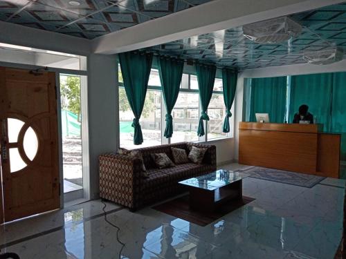 a living room with a couch and a table at Hunza Roof Hotel in Hunza