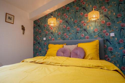 a bedroom with a yellow bed with yellow pillows at Domaine les Hilliers in Bains-sur-Oust