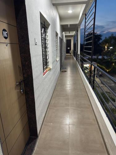 an empty hallway of a building with a balcony at Gurumauli Guesthouse in Akalkot