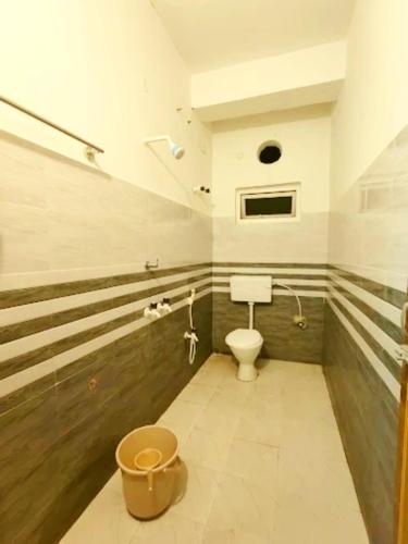 a bathroom with a toilet and a staircase at Tourist Heaven Homestay in Guwahati