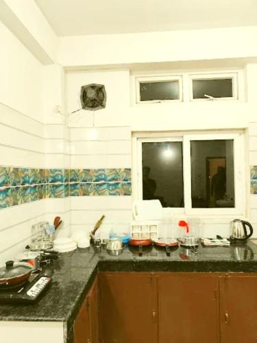 a kitchen with a counter top and a window at Tourist Heaven Homestay in Guwahati