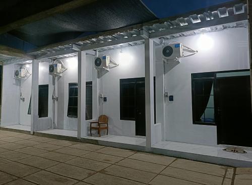 a room with multiple lights on a white wall at Alza in Tamperan