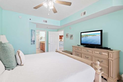 a bedroom with a bed and a flat screen tv at Ariel Dunes II 101 in Destin