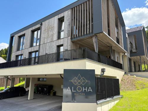 a building with a sign in front of it at Aloha Suite - Schladming Dachstein in Haus im Ennstal