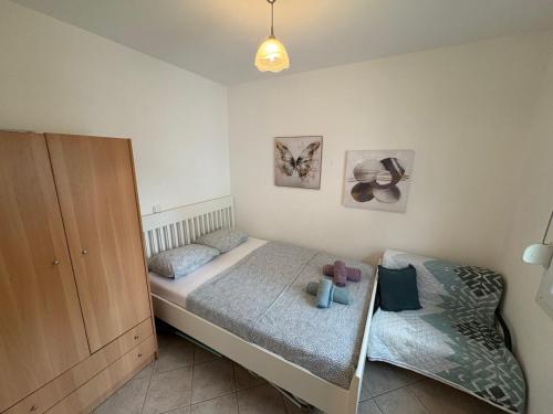 a bedroom with two twin beds and a cabinet at Polichrono Seaside Apartment in Polykhrono