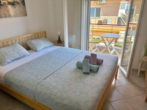 a bedroom with a bed with a teddy bear on it at Polichrono Seaside Apartment in Polykhrono