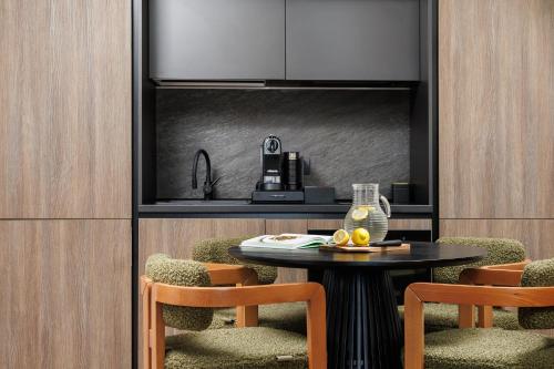 a kitchen with a table and two chairs and a sink at Mountain View Chalet - Poiana Brasov in Braşov