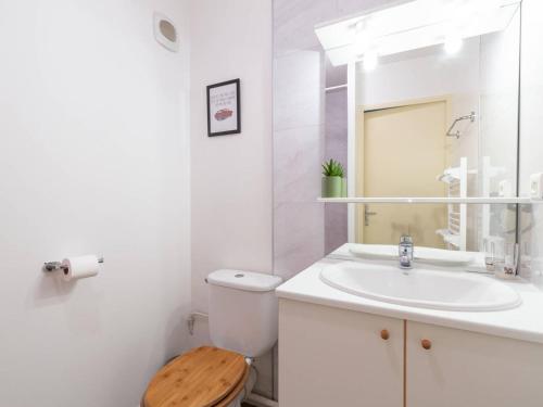 a white bathroom with a toilet and a sink at Appartement 8 pers Peyragudes, Wifi, Parking, Navette proche - FR-1-695-66 in Gouaux-de-Larboust