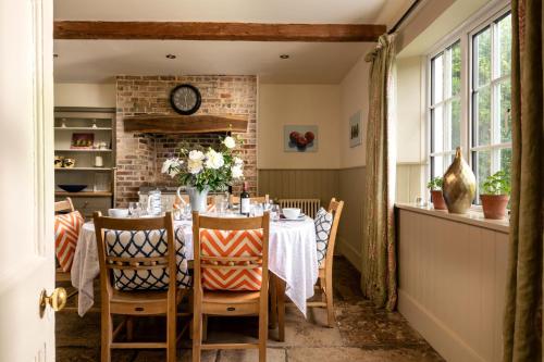 ein Esszimmer mit Tisch und Stühlen in der Unterkunft Rose Cottage - sleeps 6 in Dorchester