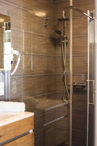 a shower with a glass door in a bathroom at Relax House Samardzic in Ličko Petrovo Selo