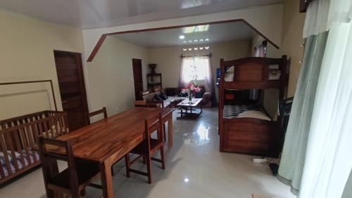 a living room with a wooden table and a bunk bed at Villa Ste Marie in Sainte Marie