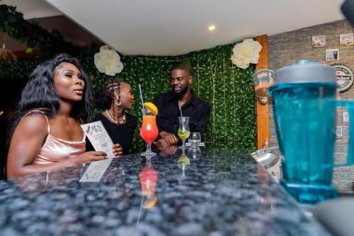 a group of people sitting at a table with drinks at Casa Mia Lodge & Restaurant in Blantyre