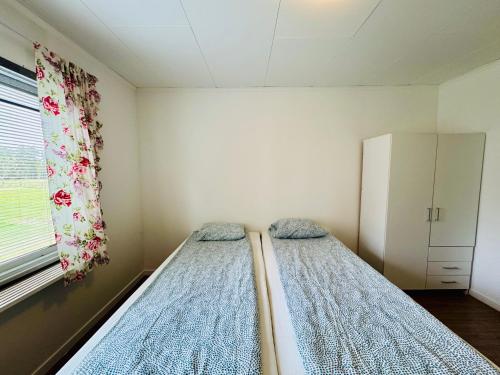 a bedroom with two beds and a window at Hässlebogården Turist & Konferens in Mariannelund