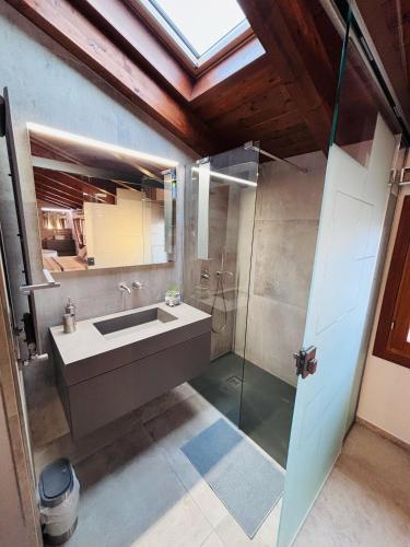 a bathroom with a sink and a glass shower at L'Appoggio in Fondi